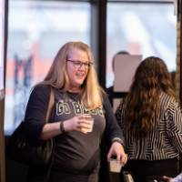 person with beverage in hand